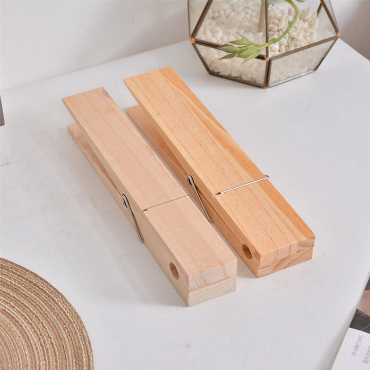 Rustic wooden towel holder with functional clothespin design, great for home organization.