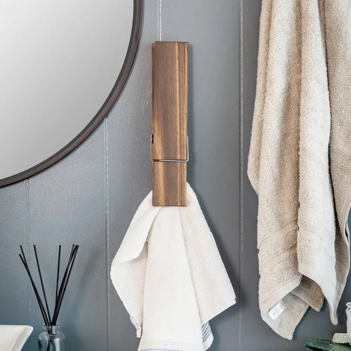 Bathroom towel holder, rustic wall mounted design, features unique clothespins for hanging.