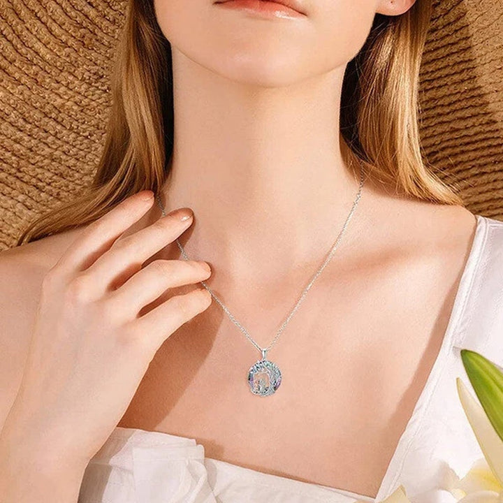 Close-up of women's silver Tree of Life necklace with sparkling crystal accents