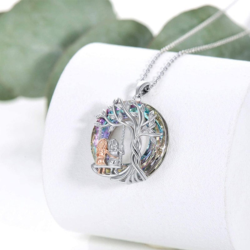 Women's silver necklace featuring a detailed Tree of Life and sister crystal