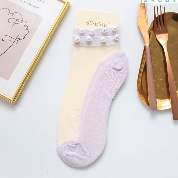 Chic women's pearl fishnet ankle socks, enhancing a fashionable and feminine look.