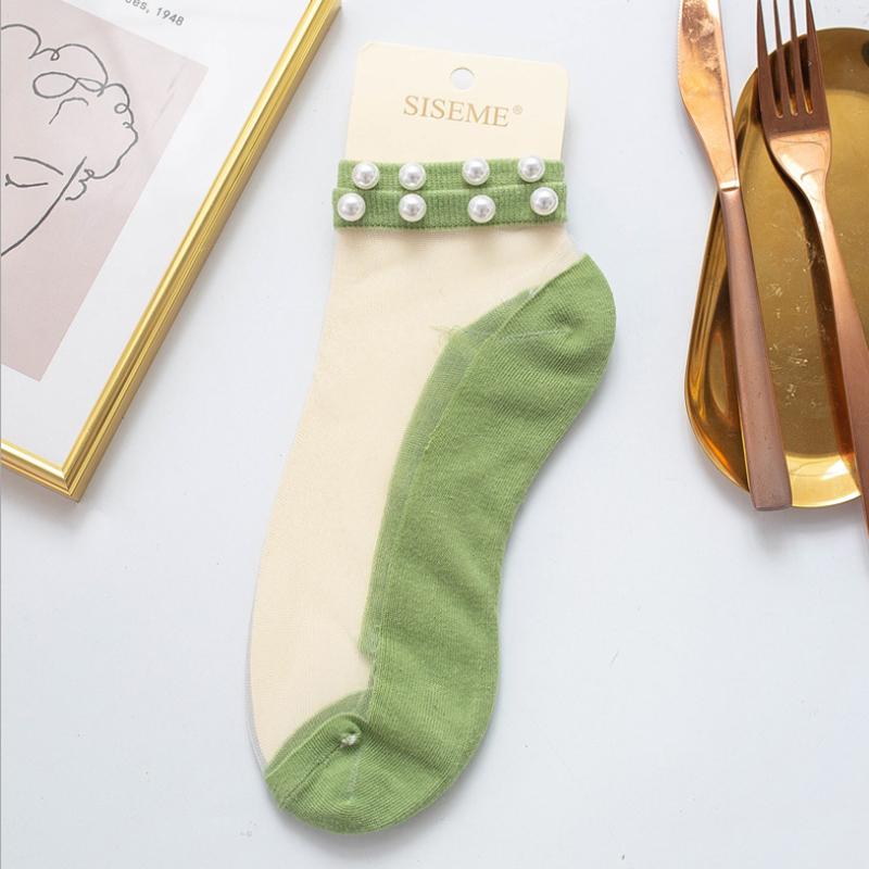 Trendy women's pearl fishnet ankle socks, a must-have fashion accessory.