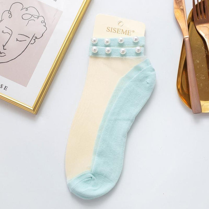 Elegant women's pearl fishnet ankle socks, a chic addition to any wardrobe.