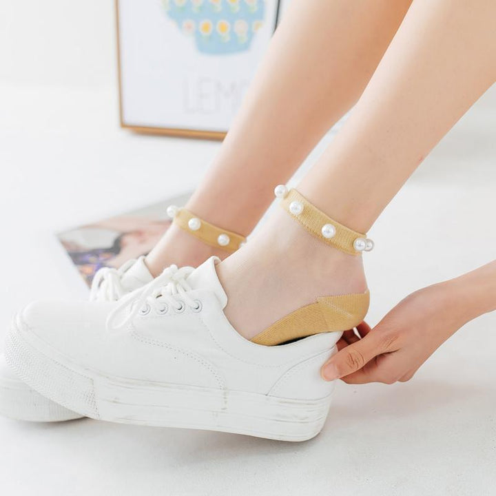 Women's black pearl fishnet ankle socks, a trendy and unique fashion statement.
