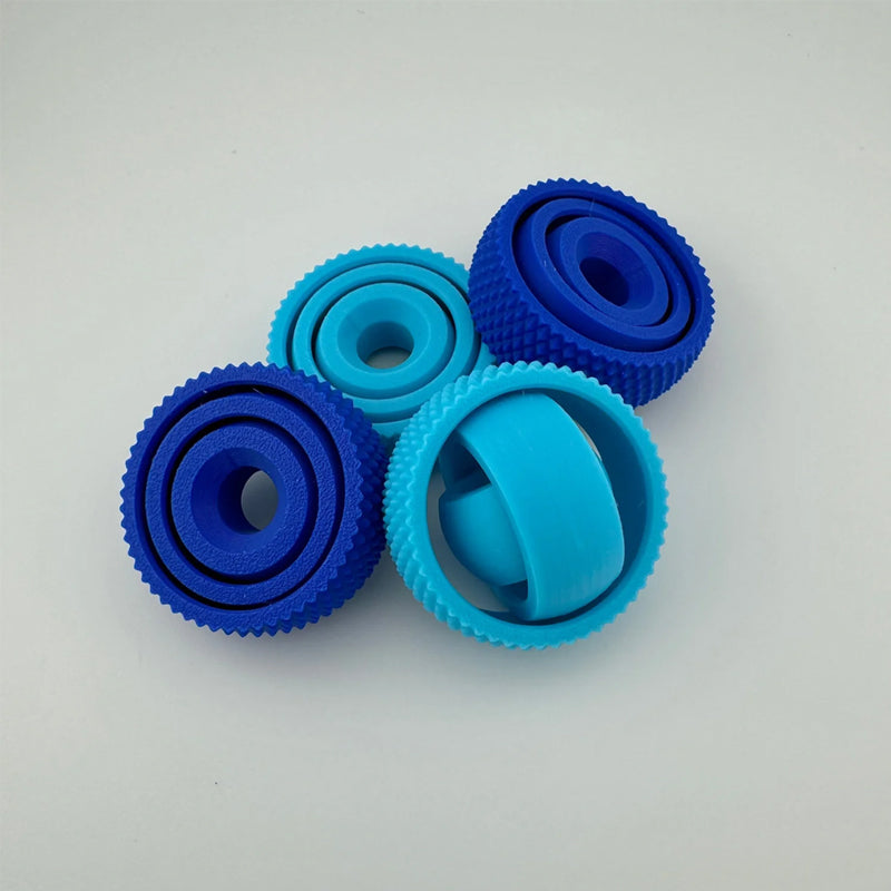 Collection of various colored 3D Concentric Ring Fidget Balls, great for sharing