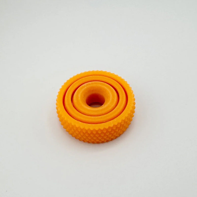 Lifestyle shot of the Concentric Ring Fidget Ball being used for anxiety relief