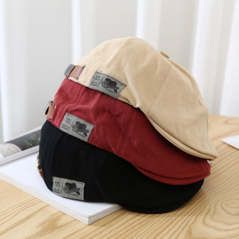 Close-up of a unisex retro cotton beret cap, showcasing its texture and classic design.
