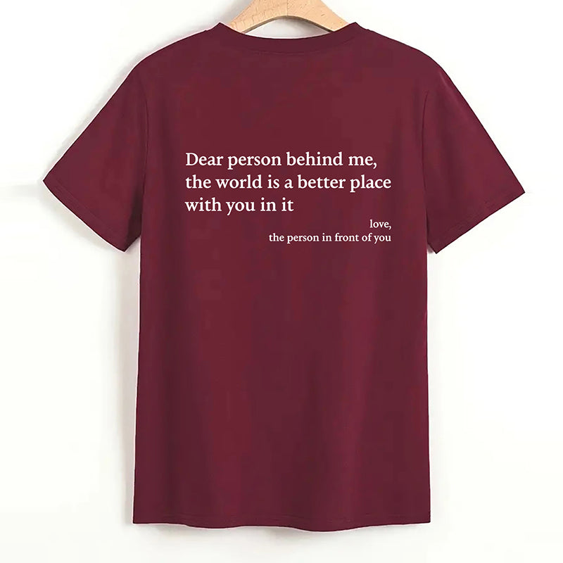 Model gesturing confidently in the 'You Are Enough' inspirational cotton top.