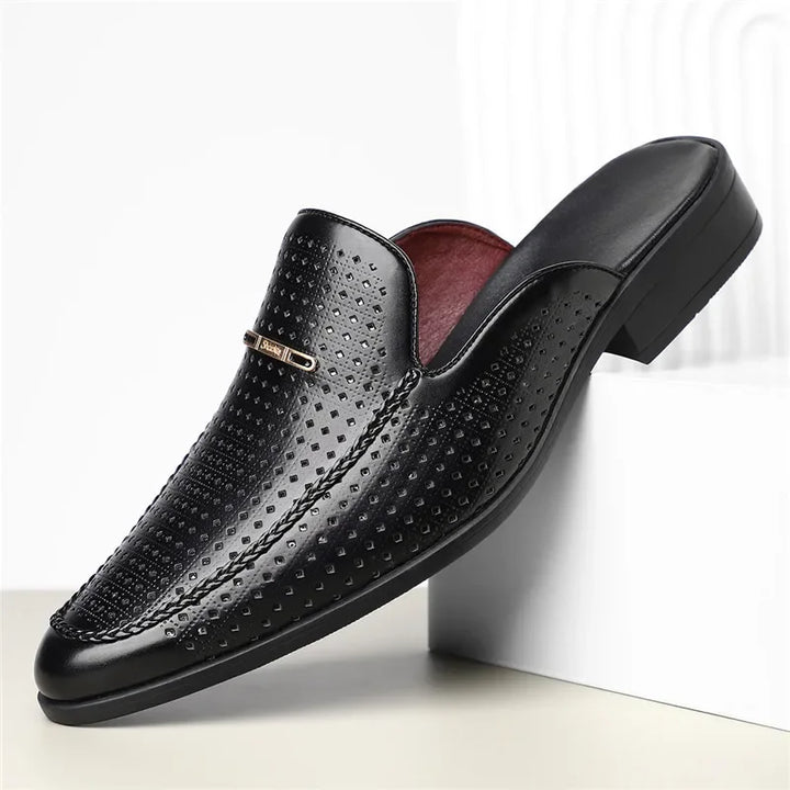 Fashionable women's perforated leather slip-on mules in a vibrant color, offering comfort