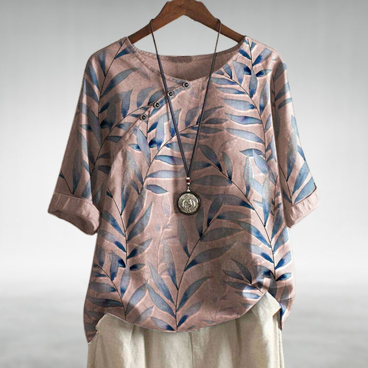 Relaxed fit women's button-up shirt with a stylish leaf print, ideal for spring tops
