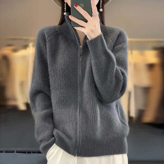 Close-up of a women's knitwear zip-front sweater showing texture and detail.