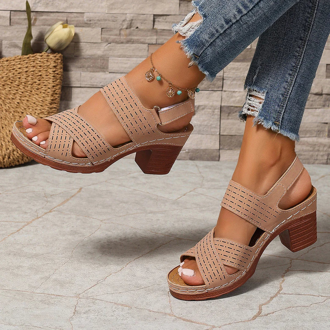 Close-up of the comfortable block heel on women's stylish summer sandals, crisscross straps visible