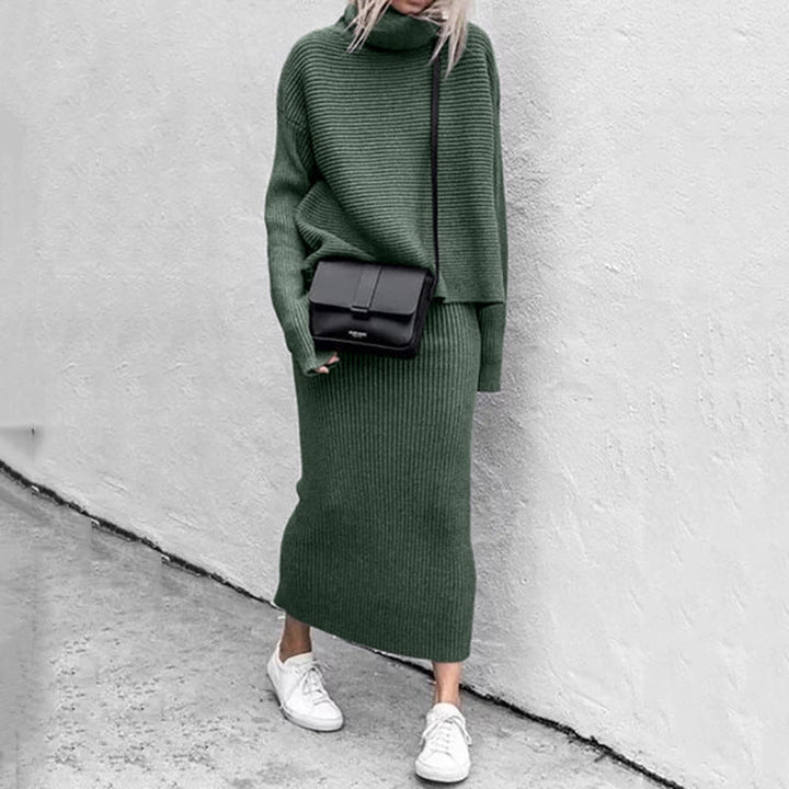 Full shot of a women's comfort wear: a knitted pullover and matching ribbed skirt set for versatile styling.