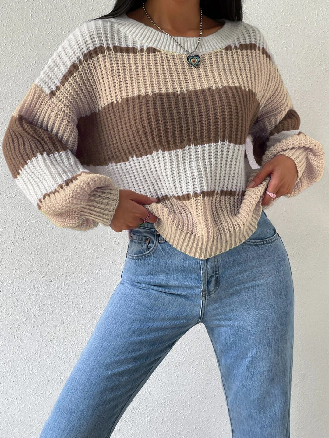 Close-up of a women's striped knit pullover sweater, showcasing the soft texture and detailed pattern.