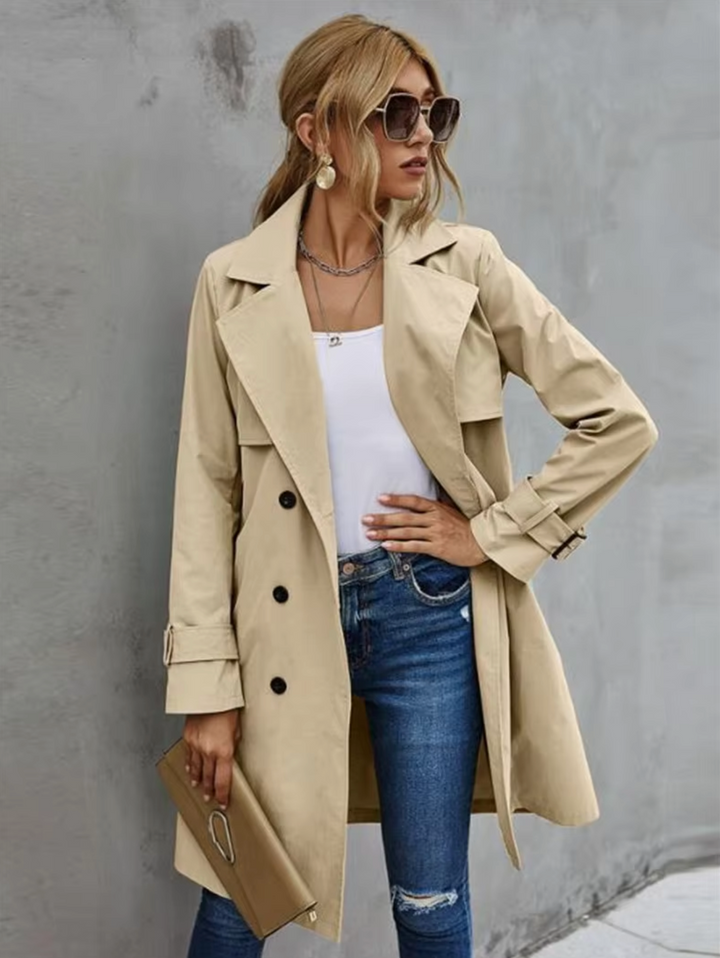 Women's double-breasted khaki trench coat with belt, showcasing classic elegant outerwear style
