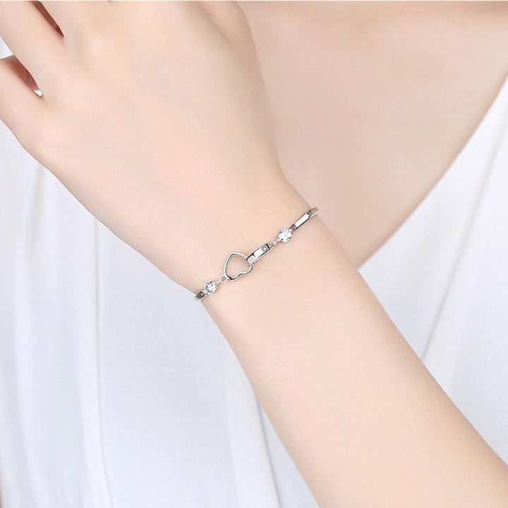 Delicate silver double heart bracelet with embedded crystals, perfect for a special gift or daily wear.