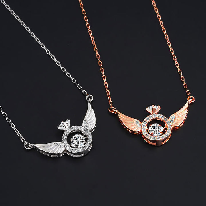 Detailed view of a women's titanium steel angel wing necklace in white gold, chic jewelry.