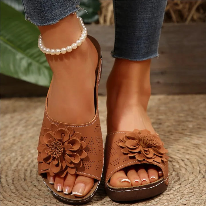 Women's fashionable slip-on sandals with a unique floral motif, essential for beach or home