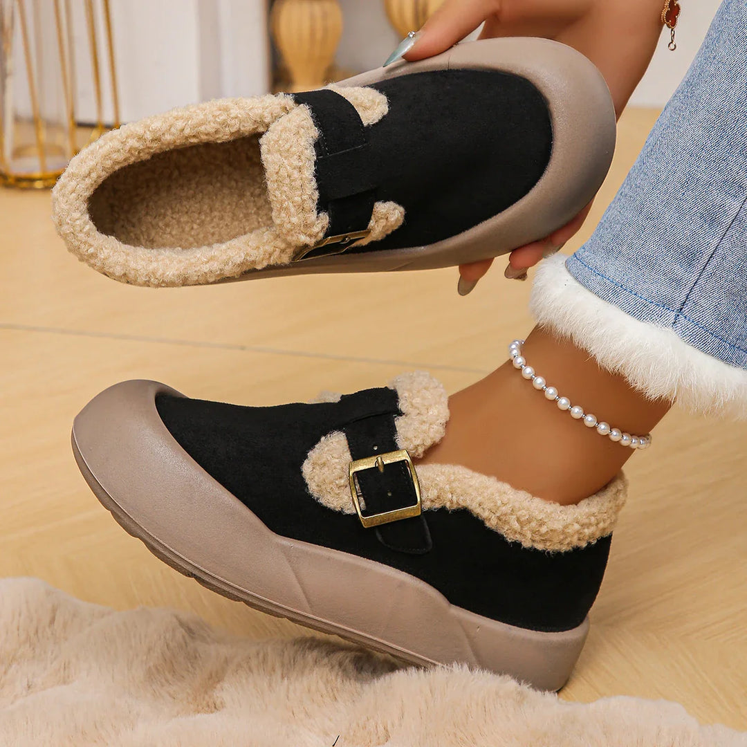 Detailed image of the genuine leather texture and adjustable buckle on women's fleece clogs.