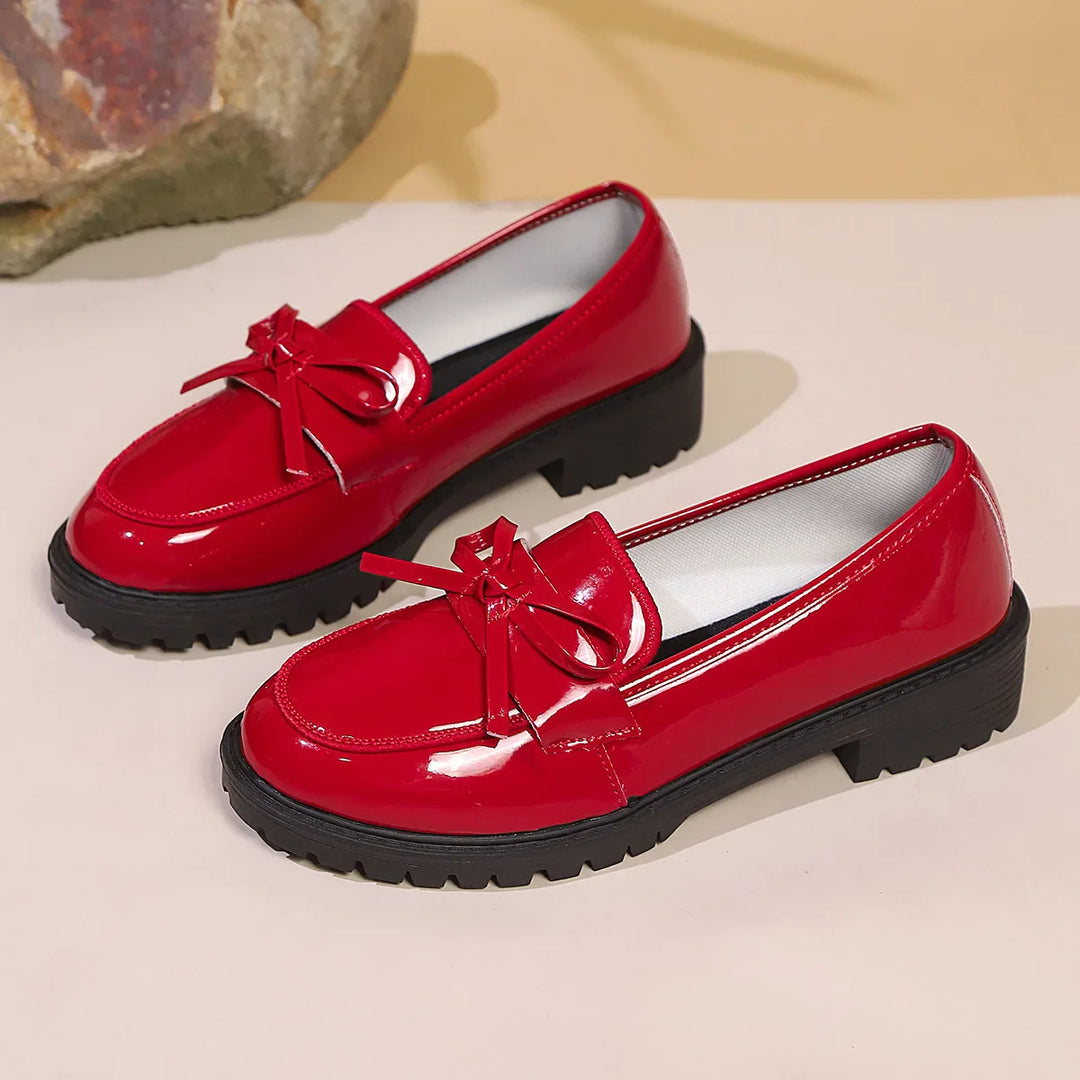 Women's dress shoes: black glossy patent loafers, offering comfort and sophistication