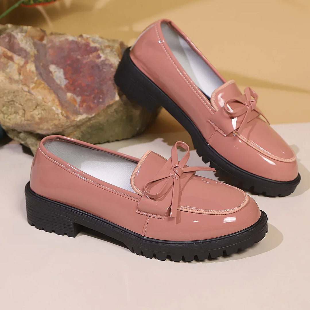 Classic women's slip-on loafers in lustrous patent leather, a timeless wardrobe staple
