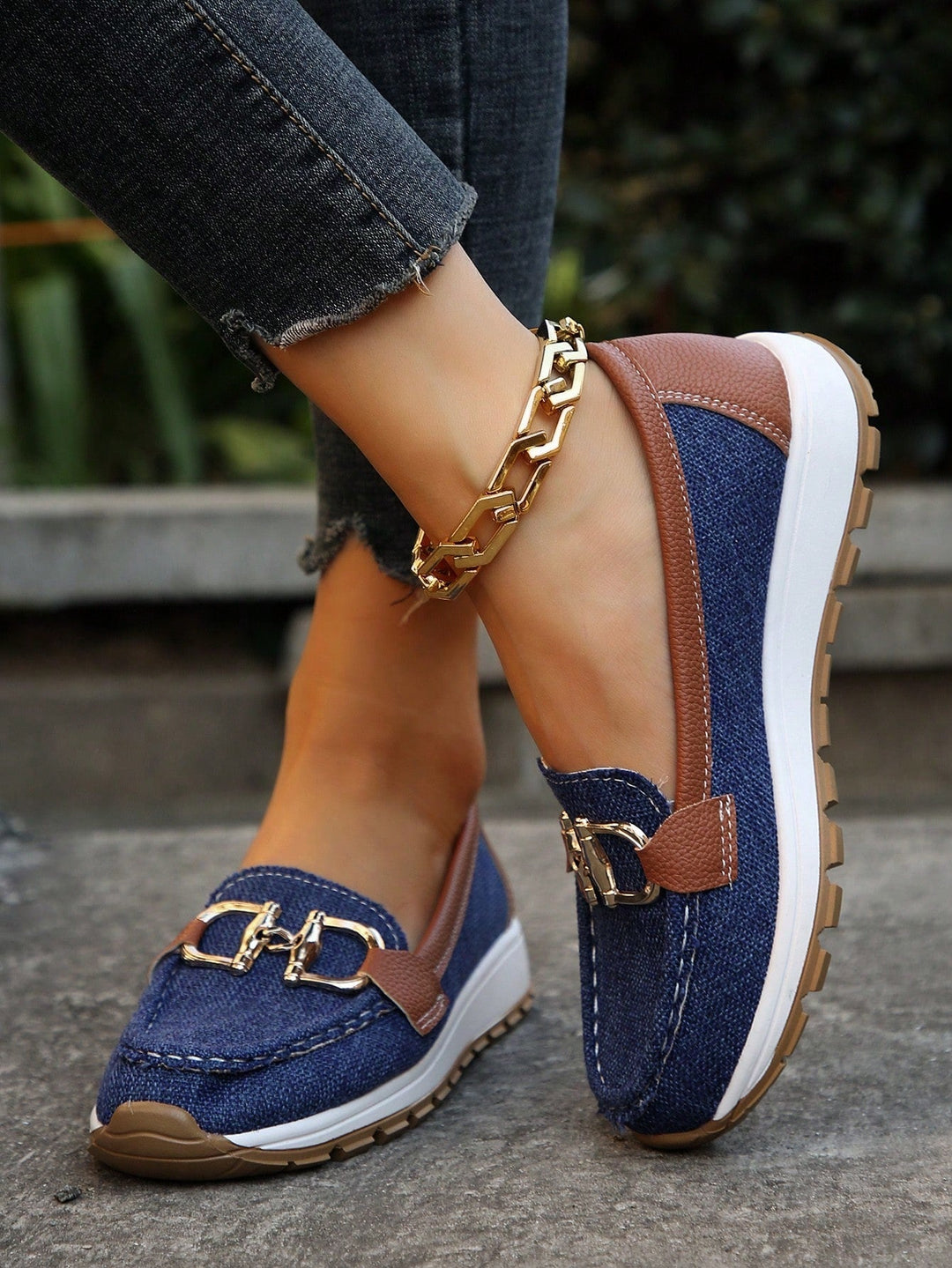 Versatile blue women's loafers, featuring a smart gold buckle for casual and dress shoe appeal.