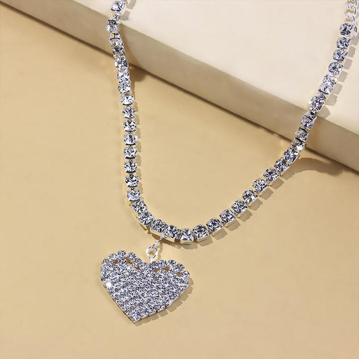 Elegant copper-toned women's anklet featuring a rhinestone heart charm, summer fashion accessory.
