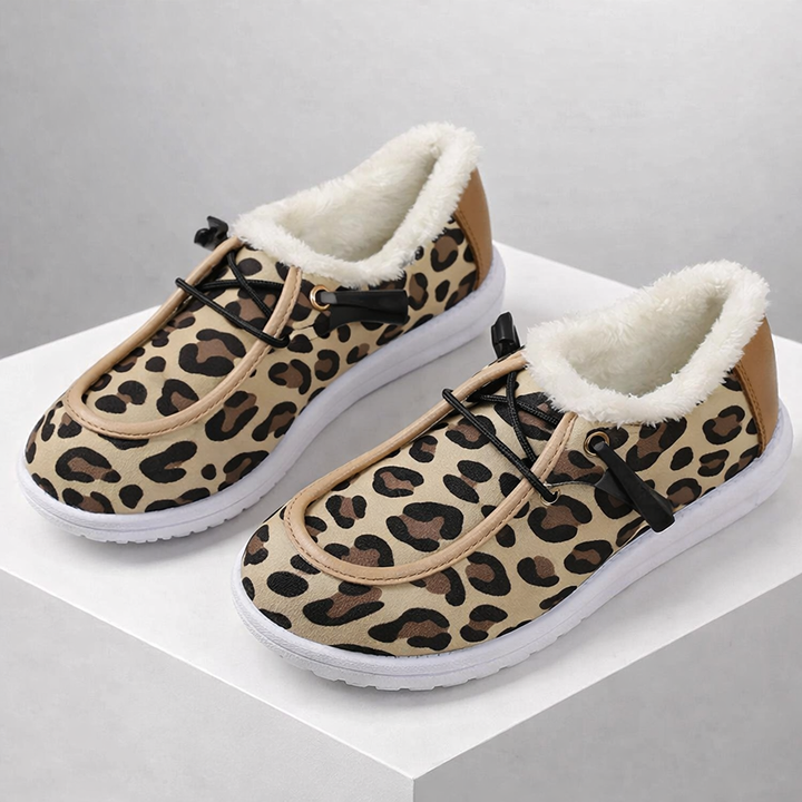 Pair of women's leopard print walking shoes, featuring a stylish design and orthopedic support.