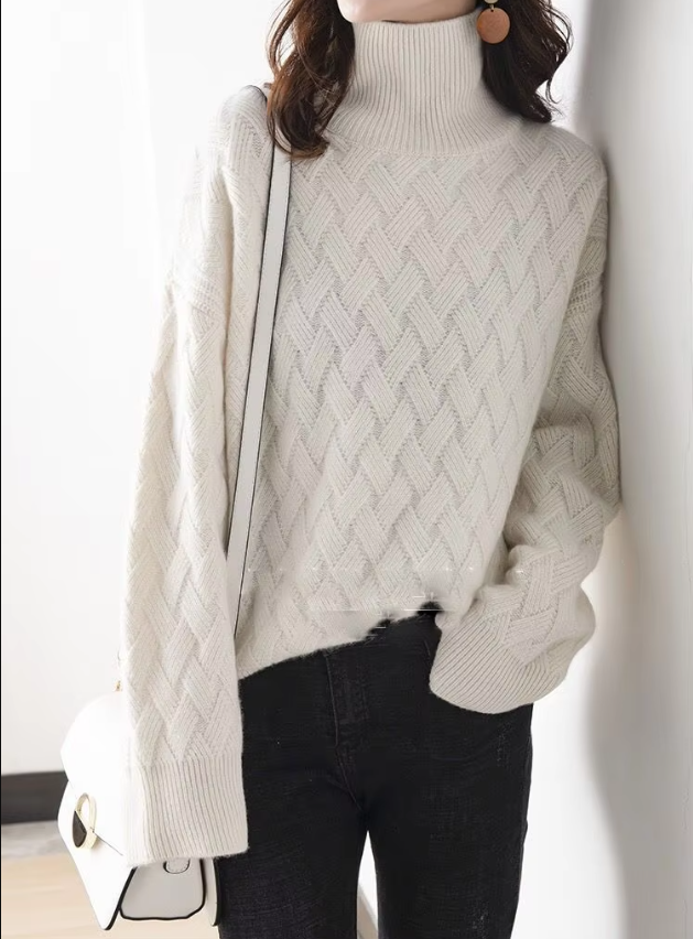 Folded green women's turtleneck spring sweater, emphasizing its soft fabric and casual chic appeal.
