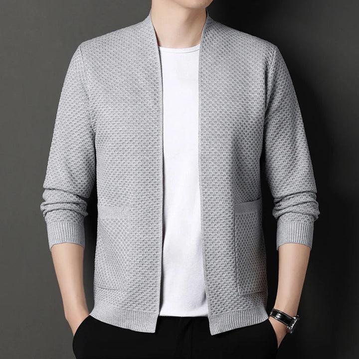 Close-up on the pocket detail of a women's open-front cardigan, perfect for storing essentials.
