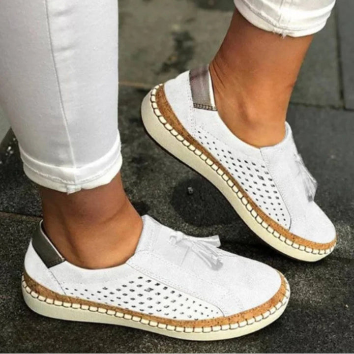 Stylish women's slip-on orthopedic shoes with tassel detail, offering arch support for spring & summer comfort.