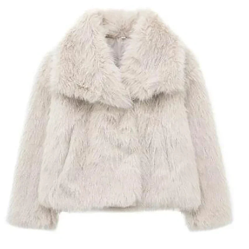Detail shot of the collar and lapel of a women's cozy faux fur jacket, highlighting its plush feel