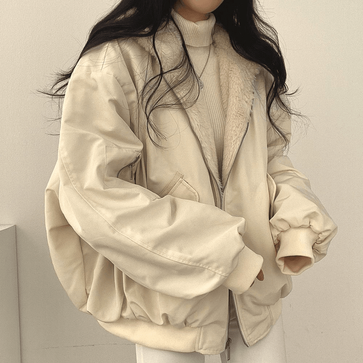 Model wearing a grey oversized winter jacket for women, showcasing its relaxed fit and stylish look.