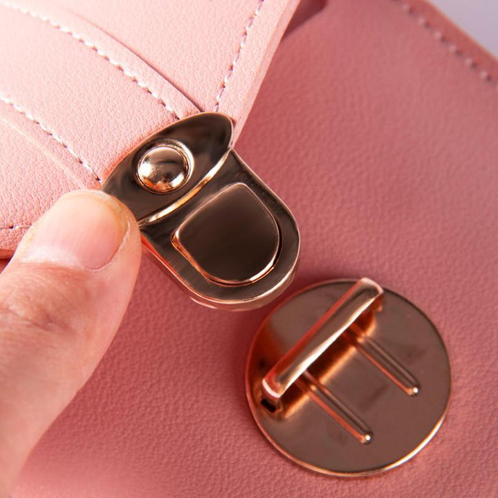 Detail of the strap attachment on a women's PU leather phone holder crossbody bag