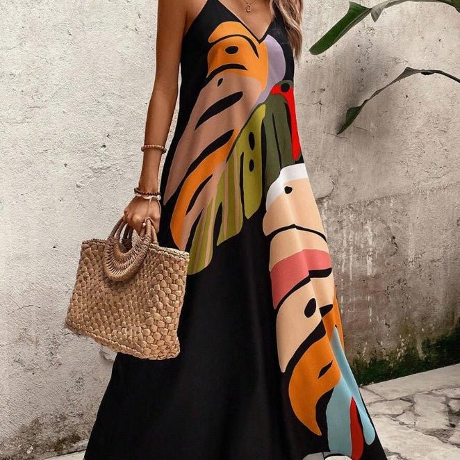 Women's tropical sleeveless maxi dress with vibrant leaf print, perfect for comfortable vacation wear.