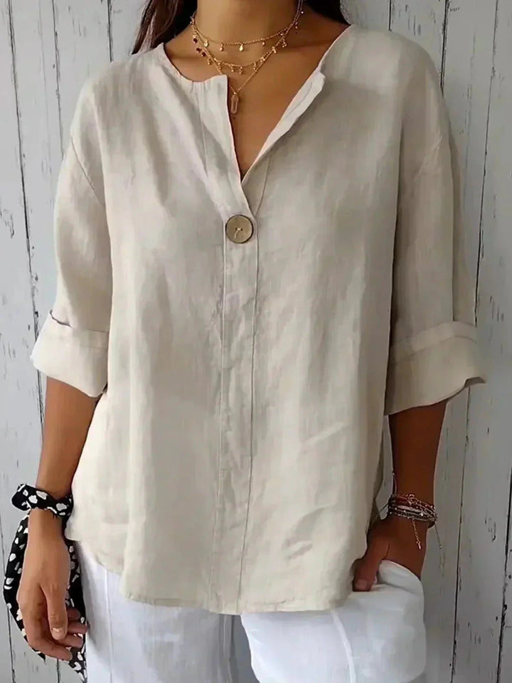 Women's V-neck blouse with adjustable roll tab long sleeves, button down, relaxed fit, versatile style.