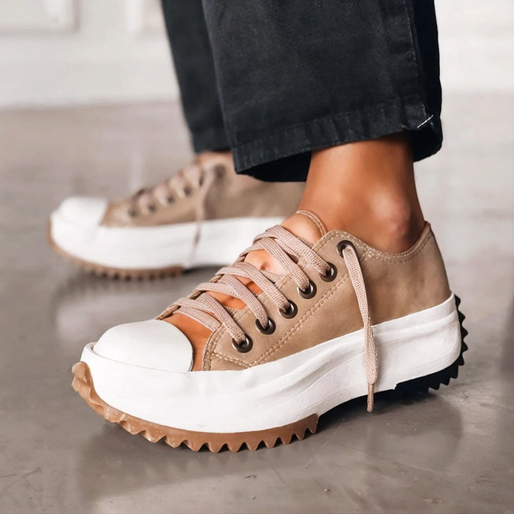 Fashionable women's platform sneakers, lace-up low-top design. Trendy casual everyday footwear with an elevated sole.